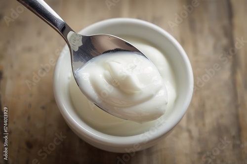 A spoon mixes sour cream in...