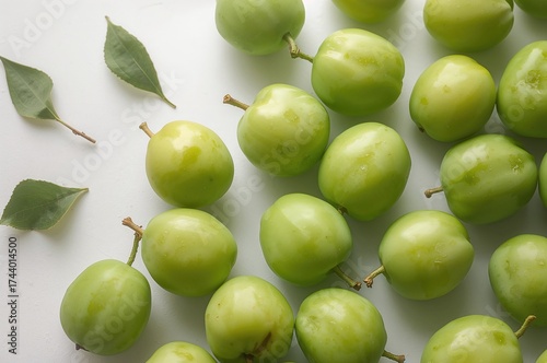 Fresh green plums against a...