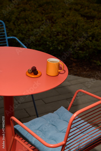 Colorful Outdoor Caf Setting with Mug and Dessert