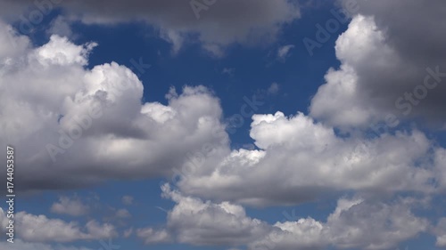 White clouds race through the bright blue sky in a beautiful time-lapse scene.