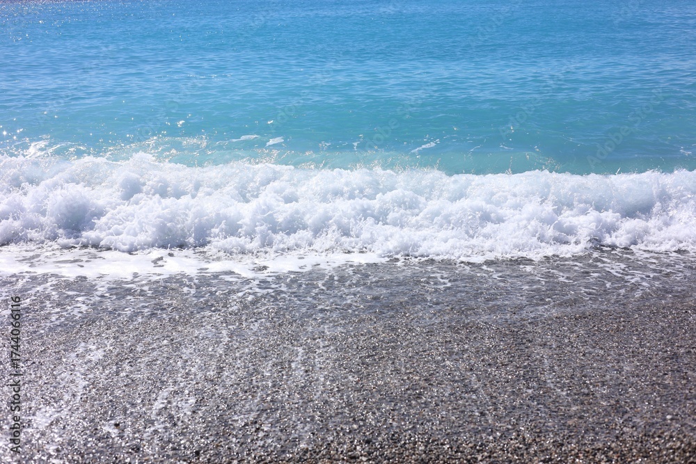 Fototapeta premium Beautiful view of wavy sea and pebbles on beach