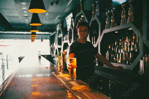 Wallpaper Mural  bartender in a pub pours draft beer behind the bar Torontodigital.ca