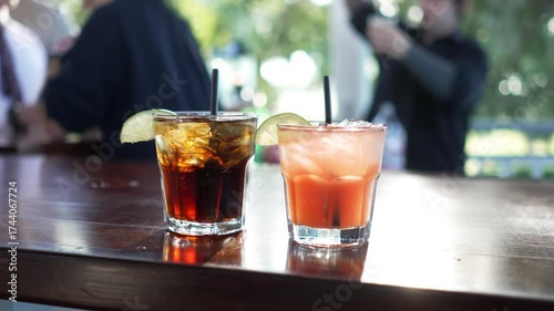 Alcoholic drinks at a party wedding reception during the day in slow motion. 