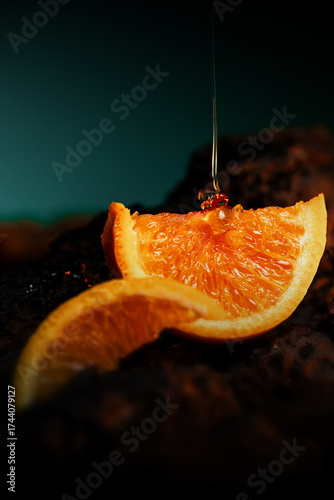 Close-up of fresh orange slices on a dark textured surface with golden honey dripping onto the fruit, captured in rich, moody lighting and vibrant natural detail.