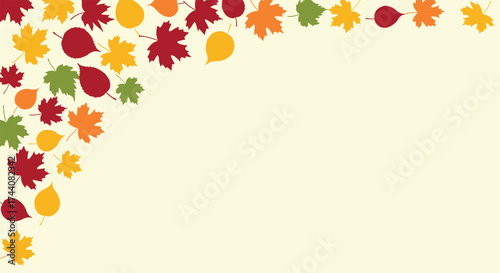 A beautiful arrangement of fall leaves in the corner of a light yellow background.