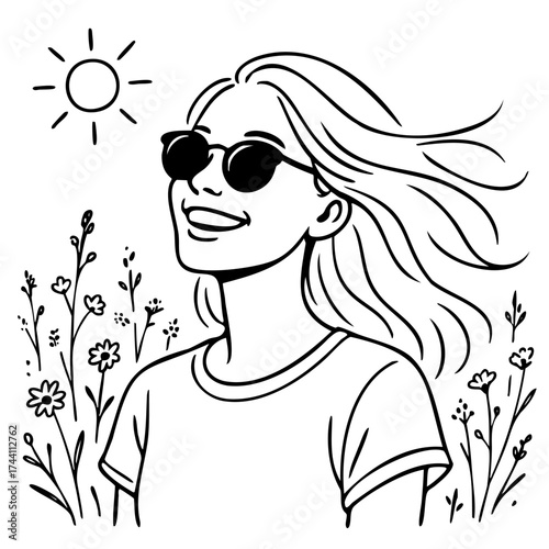 Woman with long hair is smiling and wearing sunglasses. She is standing in a field of flowers