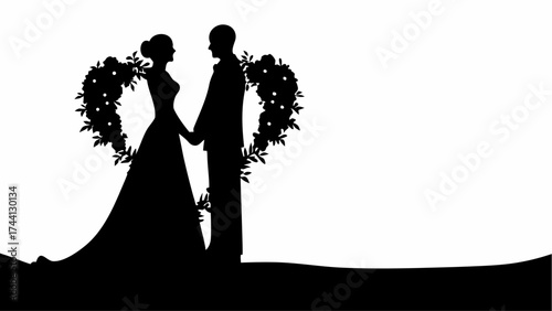 Silhouette of a bride and groom holding hands with a heart shaped floral arrangement behind them in black and white
