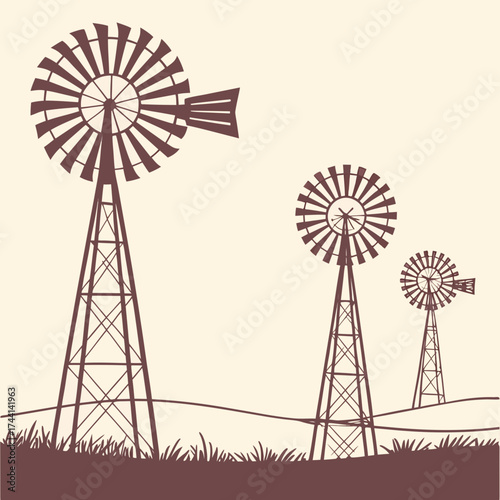 Three silhouette windmills on a grassy hillside