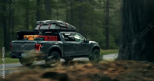 Pickup truck driving through a forested road with gear