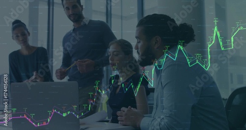 Collaborating business team analyzing financial chart on laptop in glass meeting room, with reports