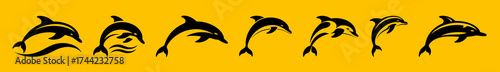 Silhouettes of dolphins leaping and swimming on a yellow background