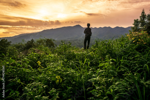 A man looking at mountain sunset