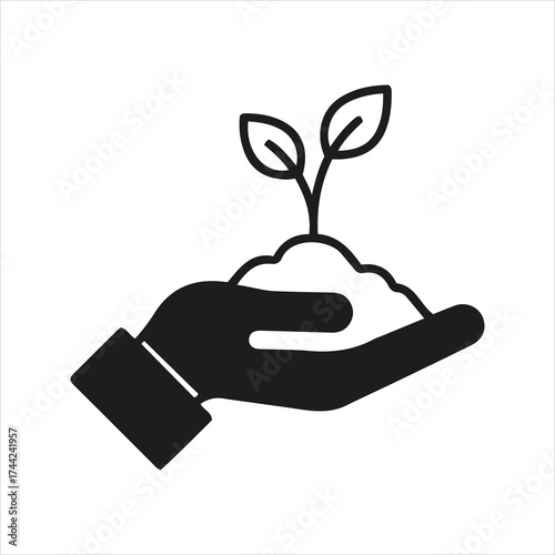 Hand holding soil with a new plant seedling symbolizing growth and new beginnings agriculture