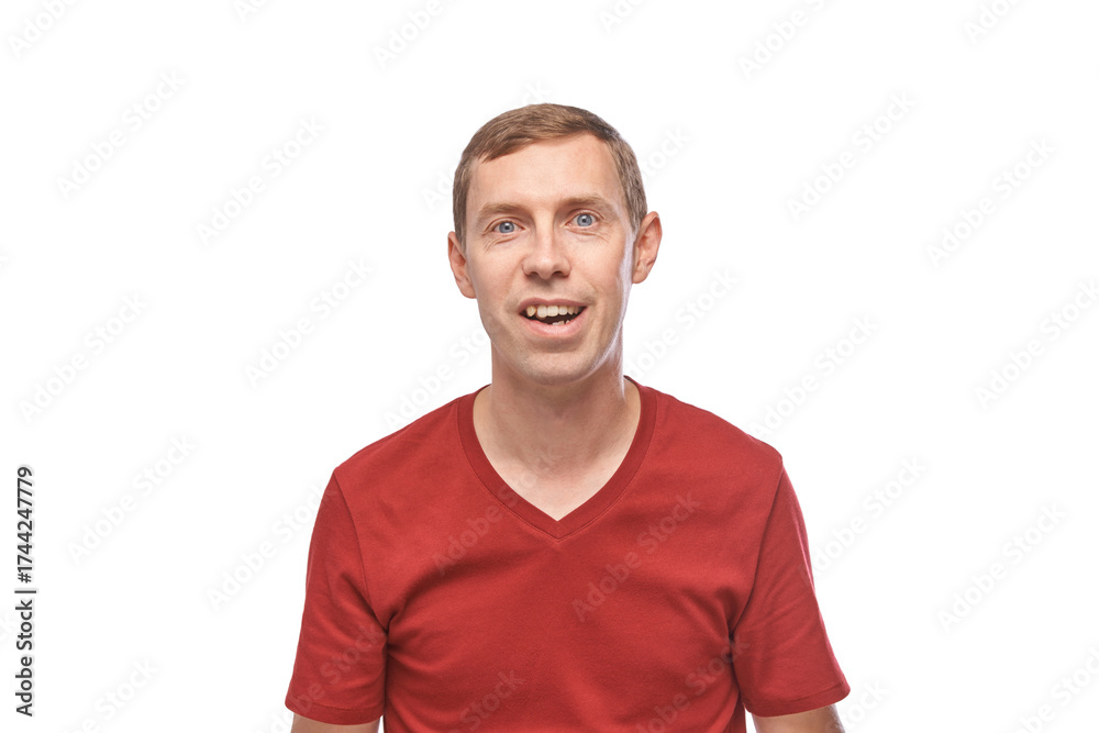 Fototapeta premium Young caucasian male smiling in red t-shirt on white background.