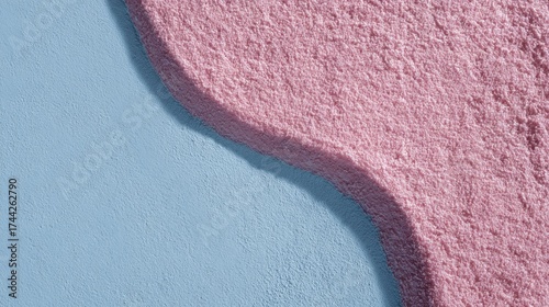 Textured pink and blue background with gentle curved shadow dividing surfaces
