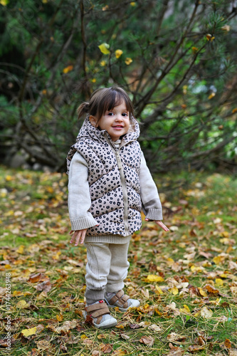 Toddler girl in autumn park