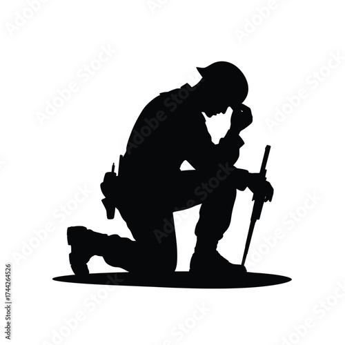 Soldier kneeling in prayer silhouette