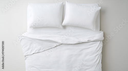 Overhead shot of bed with white bedding. Crisp, clean, and inviting. Perfect for a peaceful night's sleep and relaxation. Minimalist and modern design.
