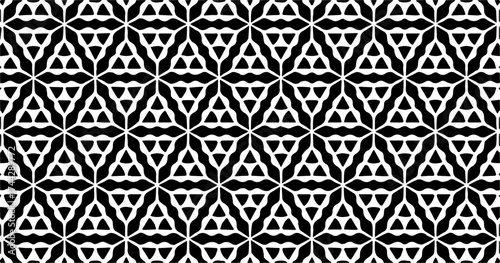 Intricate geometric seamless pattern with triangle and star elements in bold black and white, creating a complex visual rhythm.
