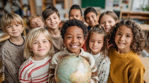 Diverse group of smiling children huddled together holding a globe, indoors, classroom setting