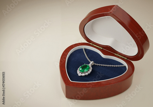Elegant green gemstone necklace in heart-shaped jewelry box  