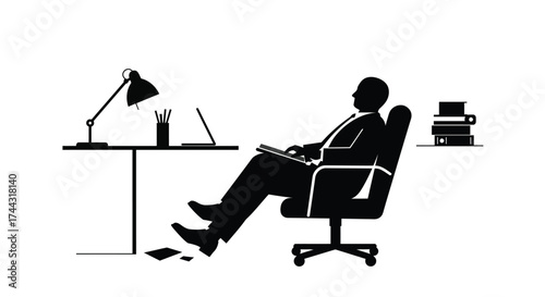 A relaxed professional works at a desk with lamp and reading material