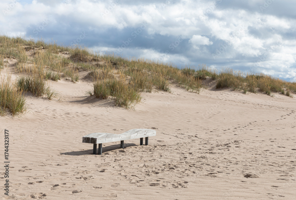 Obraz premium Sand, beach and a bench for resting