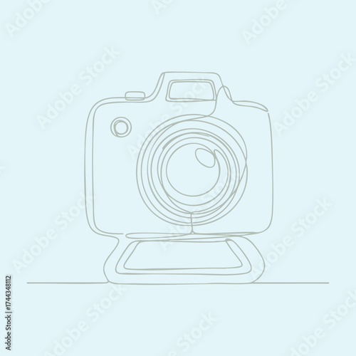 Close-up of a professional digital camera with a large lens and ergonomic design on a plain