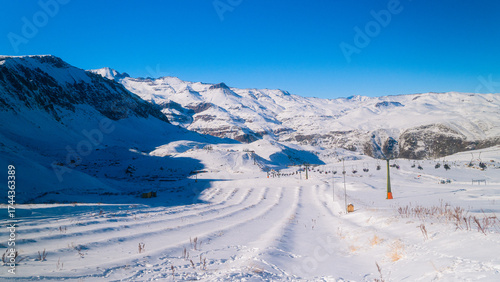 Wide landscape of Farellones, Chile, showing a snowy slope with mountains in the background