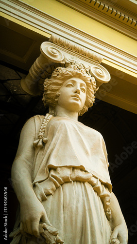 Close-up of a female statue in classical European architecture photographed from below inside a historic museum in Santiago, Chile