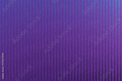 Closeup of a purple ribbed textured background with subtle glitter and a gradient effect