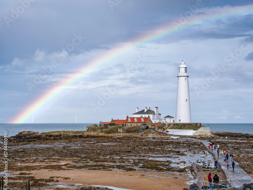 St Mary's island with causeway at low tide and natural rainbow.