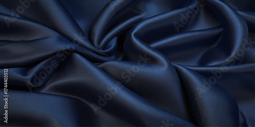 Close-up of Draped blue Satin Fabric. A close-up view of luxurious black satin fabric with dramatic folds and drapes.	