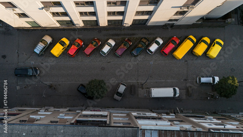 Cool photo of colorful cars against dull colored asphalt and city