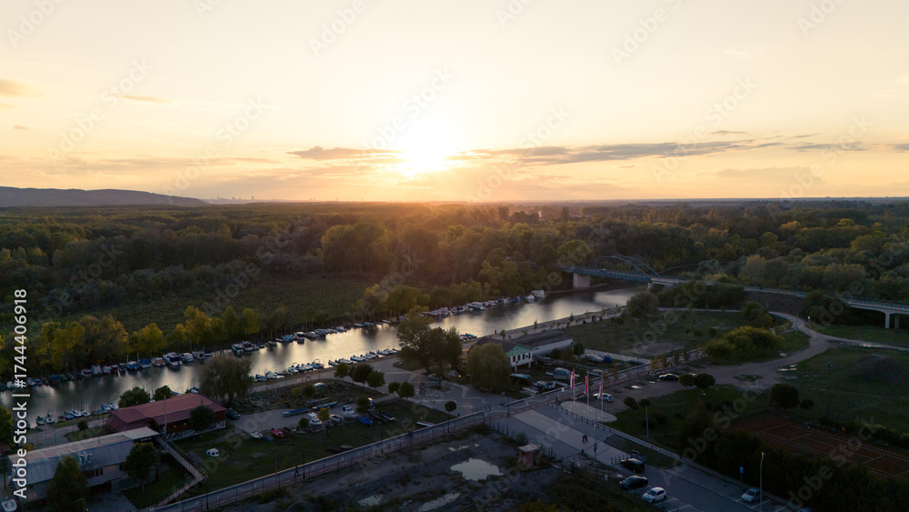 Fototapeta premium Pancevo, Serbia - 10 06 2025: Aerial shots of the town and river and city park and church