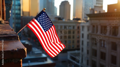 American flag waving proudly against a city skyline at sunset