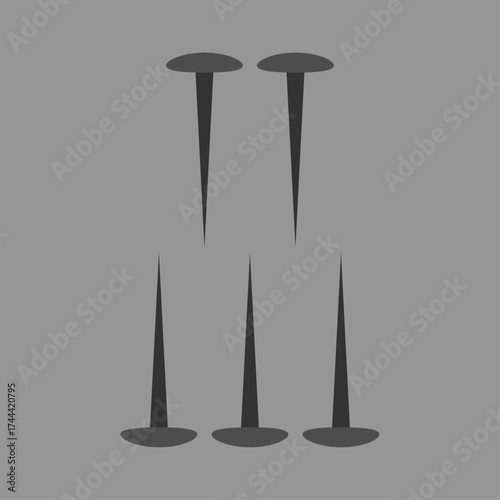 Set of five thumbtacks or pushpins displayed on a plain gray background for conceptual use