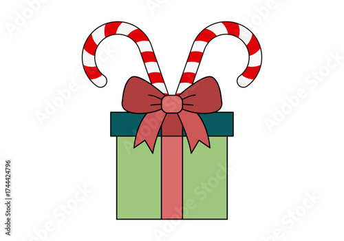 Regalo verde con lazo rojo y bastones de caramelo navideño
