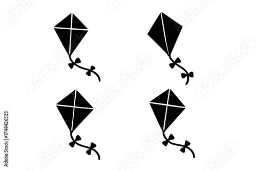Black silhouette of four diamond kites in motion