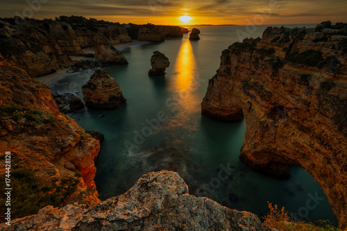 Amazing sunrise at famous beach praia da Marinha, Algarve, Portugal - travel and art concept