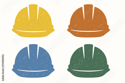 Set of four colorful construction hard hats in yellow, orange, blue, and green