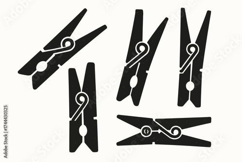 Set of black clothespins on white background