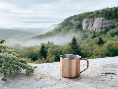 Morning coffee in a hammered copper mug overlooking a misty mountain forest landscape, a serene and tranquil natural view.