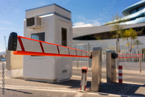 Konstfotografi Automatic security barrier gate at parking entrance with small guard booth and a