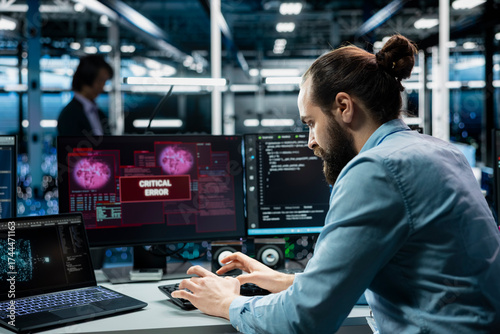 Data center programmer typing on PC keyboard, fixing error warning popup on screen using generative AI. Server hub worker using artificial intelligence chatbot to eliminate glitch alert on monitor