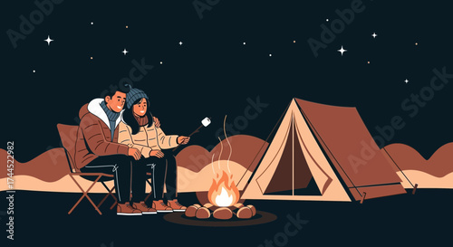 Couple enjoying a night camping together with a campfire under the starry night sky
