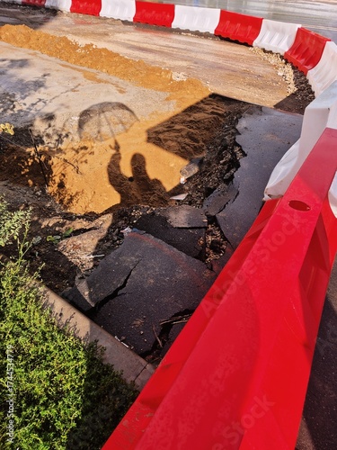 Unexpected road damage creates a hazardous area