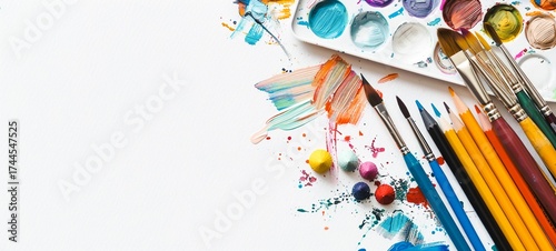 Assortment of vibrant art supplies and tools including paint brushes color palette pencils markers and other creative materials on a white background  Concept of creativity hobby education