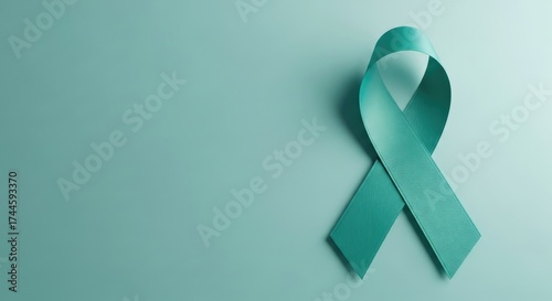 Teal Ribbon Symbolizing Awareness and Support for Ovarian Cancer and Cervical Cancer on a Matching Teal Background