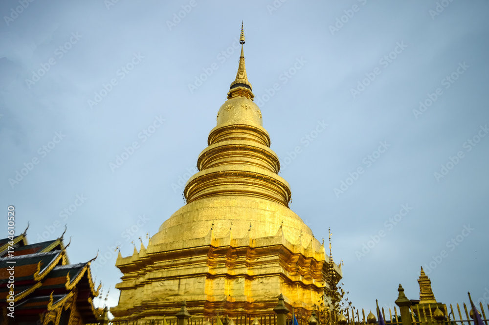 Fototapeta premium Pagoda and Chapel, Lanna Architecture, Symbols of Buddhism, South East Asia at Wat Phra That Hariphunchai, Lamphun, Northern Thailand